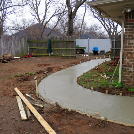 Concrete sidewalk being constructed with wood frame and cement